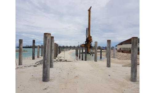 Piles installed along a beach for a marine structure