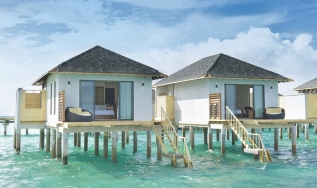 Overwater villas on piles above a lagoon, illustrative of the resort typology