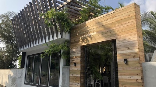 Timber-clad hospitality building with slatted screens